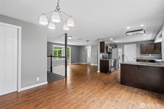 29319 132nd Ave E, Graham, WA 98338 - kitchen with stainless steel appliances, dark brown cabinetry, open floor plan, dark wood-style floors, and recessed lighting