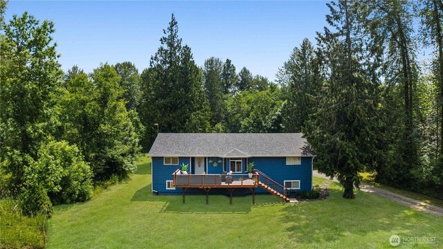 29319 132nd Ave E, Graham, WA 98338 - view of front facade featuring a wooden deck, a front lawn, a view of trees, and stairway