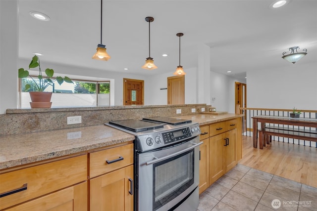 13102 16th Ave SW, Burien, WA 98146 - kitchen with stainless steel electric range oven, light tile patterned flooring, recessed lighting, hanging light fixtures, and light stone counters