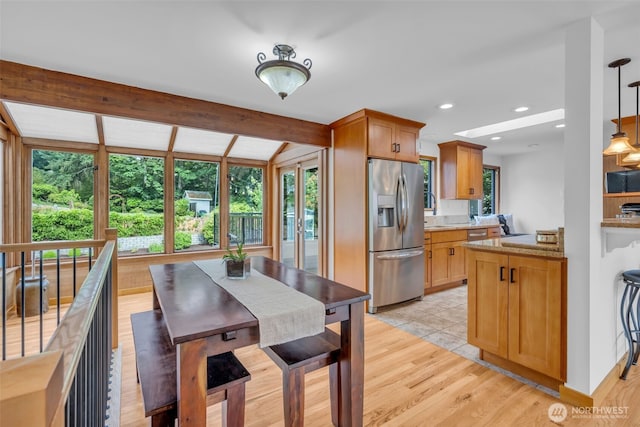 13102 16th Ave SW, Burien, WA 98146 - kitchen featuring stainless steel refrigerator with ice dispenser, light wood-style flooring, pendant lighting, light stone counters, and recessed lighting