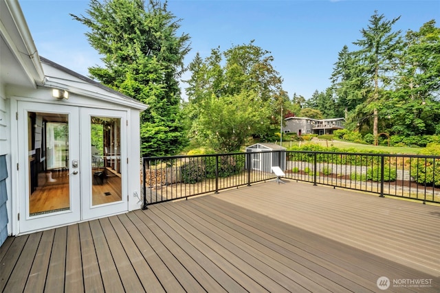 13102 16th Ave SW, Burien, WA 98146 - wooden terrace featuring view of wooded area, a storage unit, and french doors