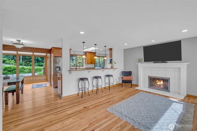 13102 16th Ave SW, Burien, WA 98146 - living room featuring light wood-style flooring, a fireplace, and recessed lighting