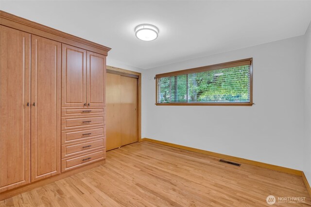 13102 16th Ave SW, Burien, WA 98146 - unfurnished bedroom with light wood finished floors and a closet