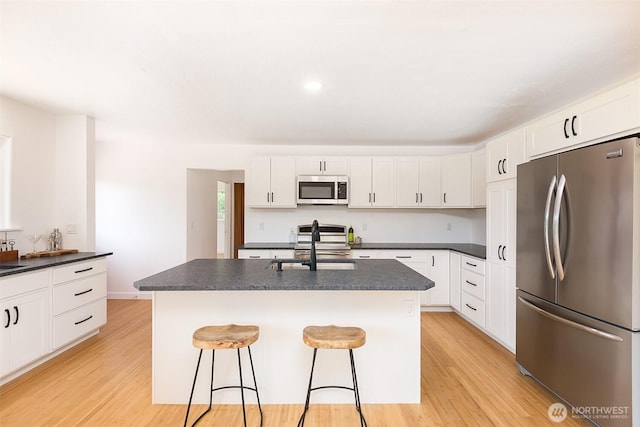 150 Sunland Dr, Sequim, WA 98382 - kitchen featuring appliances with stainless steel finishes, dark countertops, and light wood-style floors