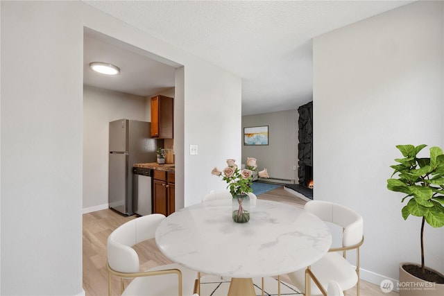 4709 176th St SW Unit C1, Lynnwood, WA 98037 - dining room featuring light wood-style flooring and a baseboard heating unit