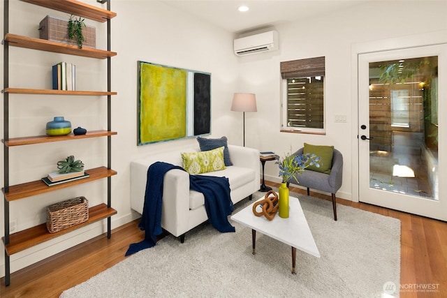 3626 1st Ave NW Unit A, Seattle, WA 98107 - living room featuring a wall mounted air conditioner, wood finished floors, and recessed lighting