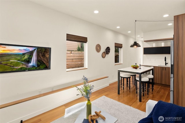 3626 1st Ave NW Unit A, Seattle, WA 98107 - dining space featuring bar with sink, light wood finished floors, and recessed lighting