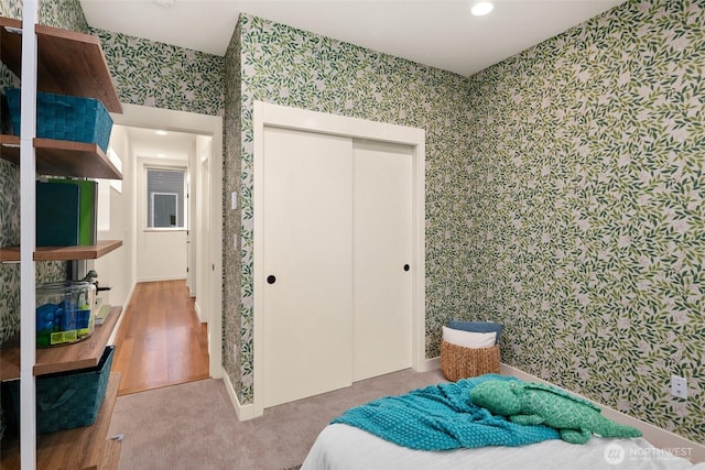 3626 1st Ave NW Unit A, Seattle, WA 98107 - bedroom featuring wallpapered walls, a closet, recessed lighting, and wood finished floors