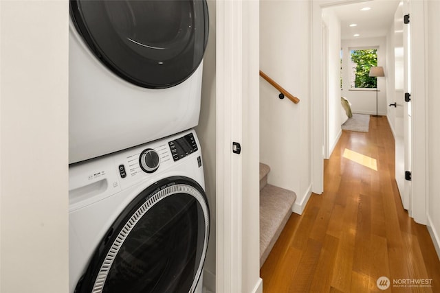 3626 1st Ave NW Unit A, Seattle, WA 98107 - washroom featuring stacked washer and clothes dryer, wood finished floors, and recessed lighting