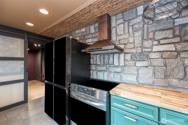 218 125th St S, Tacoma, WA 98444 - kitchen with stainless steel electric range, butcher block countertops, a barn door, freestanding refrigerator, and blue cabinetry