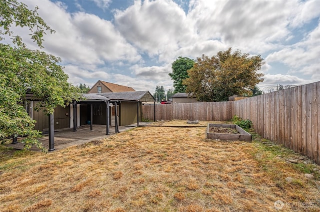 218 125th St S, Tacoma, WA 98444 - fenced backyard featuring a vegetable garden and a patio