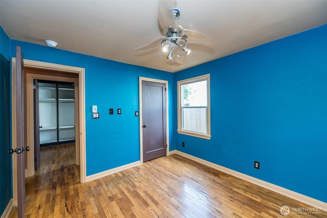 218 125th St S, Tacoma, WA 98444 - unfurnished bedroom featuring wood-type flooring, a ceiling fan, and a closet