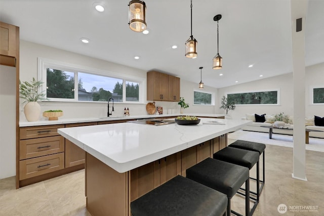 16121 Cedar Grove Rd SE, Issaquah, WA 98027 - kitchen with light countertops, a center island, a kitchen breakfast bar, recessed lighting, and decorative light fixtures