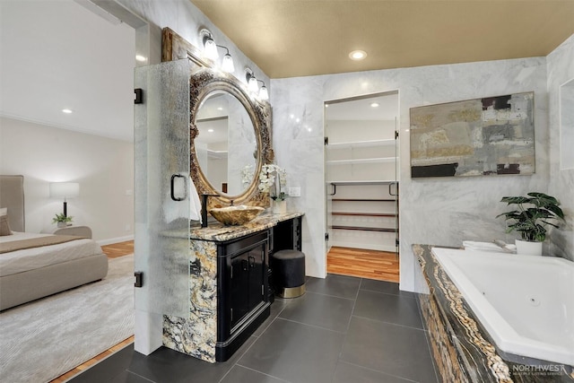 16121 Cedar Grove Rd SE, Issaquah, WA 98027 - full bathroom with vanity, tile patterned floors, a tub with jets, recessed lighting, and tile walls