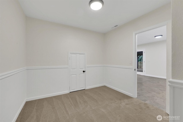 16121 Cedar Grove Rd SE, Issaquah, WA 98027 - empty room featuring carpet flooring and a wainscoted wall