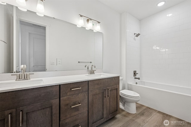 15406 210th Ave E Unit 317, Bonney Lake, WA 98391 - bathroom with wood finished floors, double vanity, shower / tub combination, and recessed lighting