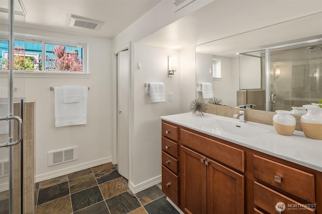 6045 36th Ave SW, Seattle, WA 98126 - full bathroom featuring vanity, healthy amount of natural light, a shower stall, and stone finish flooring