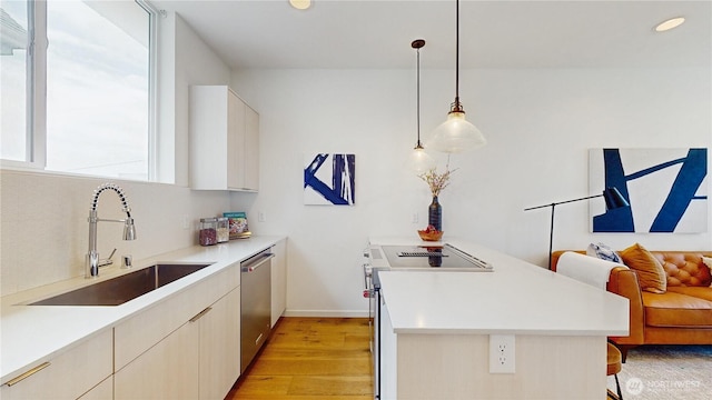 4250 Linden Ave N, Seattle, WA 98103 - kitchen featuring white range with electric cooktop, stainless steel dishwasher, a peninsula, a kitchen breakfast bar, and light wood-style floors