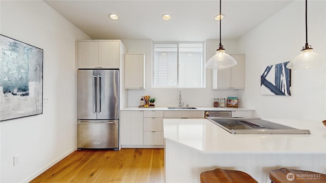 4250 Linden Ave N, Seattle, WA 98103 - kitchen featuring stainless steel appliances, modern cabinets, light wood-type flooring, light countertops, and recessed lighting