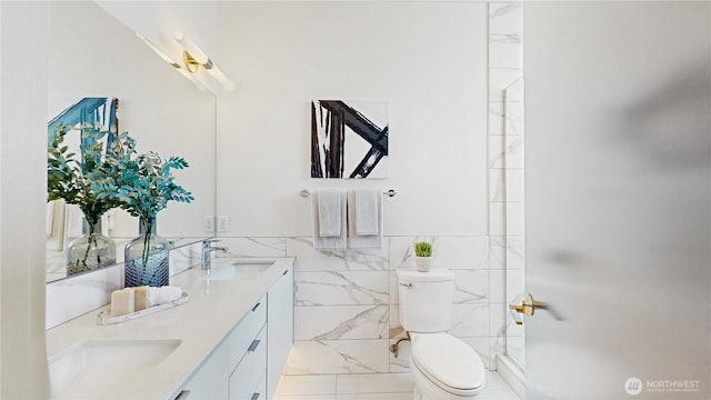 4250 Linden Ave N, Seattle, WA 98103 - bathroom featuring double vanity, tile walls, a shower, and wainscoting
