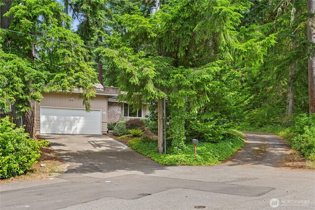 18020 SE 146th St, Renton, WA 98059 - view of property hidden behind natural elements with driveway and an attached garage