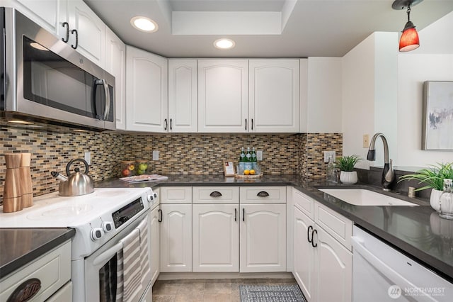 11011 NE 12th St Unit 501, Bellevue, WA 98004 - kitchen featuring white appliances, dark countertops, white cabinetry, recessed lighting, and decorative backsplash