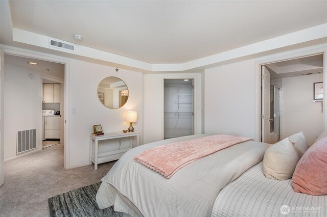 11011 NE 12th St Unit 501, Bellevue, WA 98004 - bedroom featuring carpet floors and washing machine and dryer