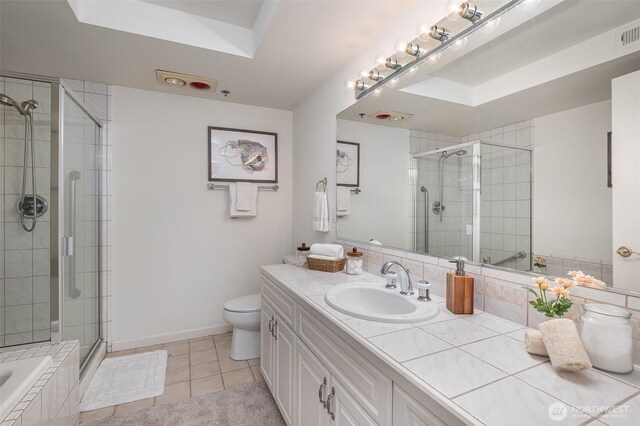 11011 NE 12th St Unit 501, Bellevue, WA 98004 - full bathroom with vanity, tile patterned floors, a stall shower, and a relaxing tiled tub