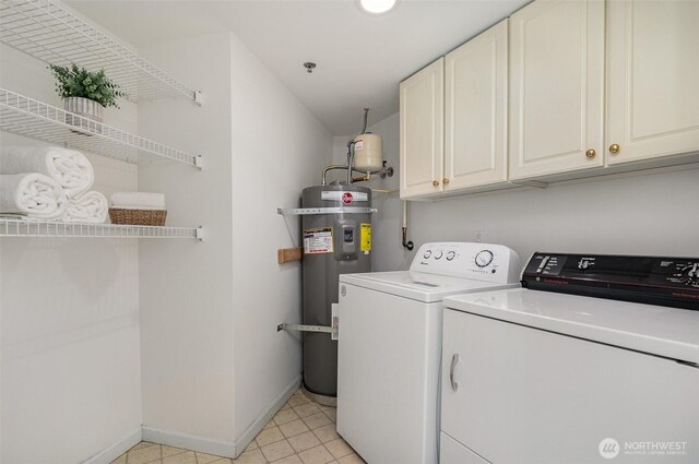 11011 NE 12th St Unit 501, Bellevue, WA 98004 - laundry area featuring secured water heater, washer and dryer, cabinet space, and light tile patterned floors