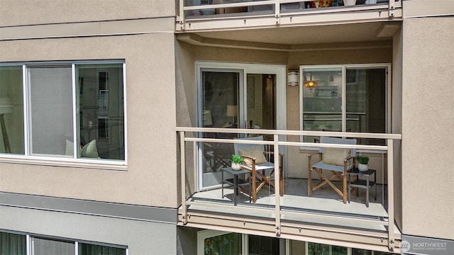 11011 NE 12th St Unit 501, Bellevue, WA 98004 - view of home's exterior with a balcony and stucco siding