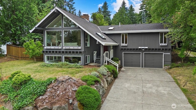 4505 144th Ave SE, Bellevue, WA 98006 - view of front of home with driveway, a chimney, a garage, a shingled roof, and a front yard