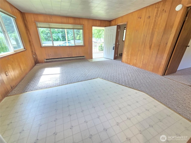 362 Lakeside Dr, Sedro Woolley, WA 98284 - carpeted spare room with a baseboard heating unit, healthy amount of natural light, wood walls, and tile patterned floors