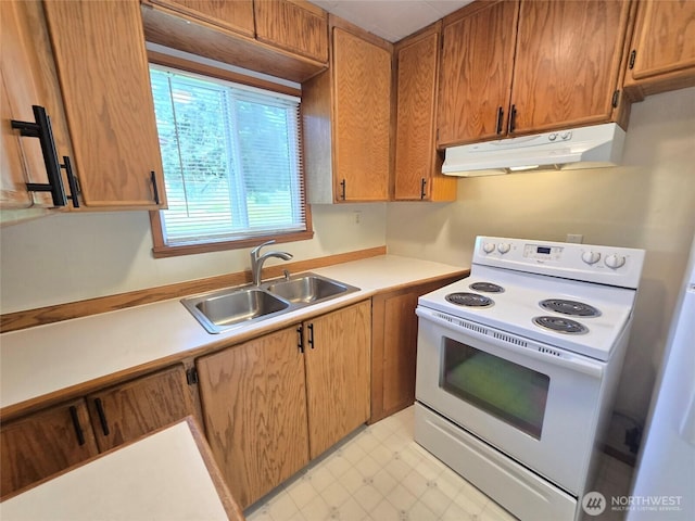 362 Lakeside Dr, Sedro Woolley, WA 98284 - kitchen with electric range, under cabinet range hood, light countertops, brown cabinets, and light flooring