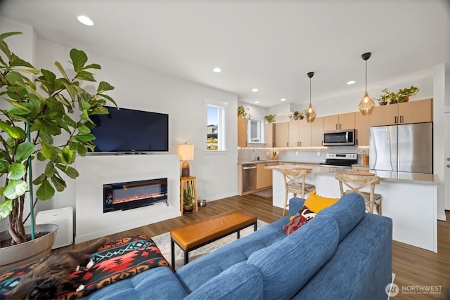 4243 Cameo Ln, Bellingham, WA 98226 - living area with dark wood-style flooring, a glass covered fireplace, and recessed lighting