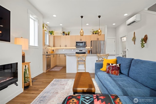 4243 Cameo Ln, Bellingham, WA 98226 - living room with a wall mounted air conditioner, light wood-style flooring, and recessed lighting
