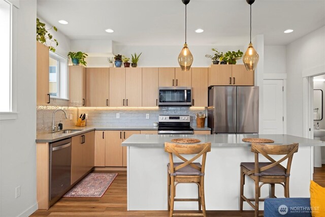 4243 Cameo Ln, Bellingham, WA 98226 - kitchen with appliances with stainless steel finishes, light brown cabinets, backsplash, wood finished floors, and recessed lighting
