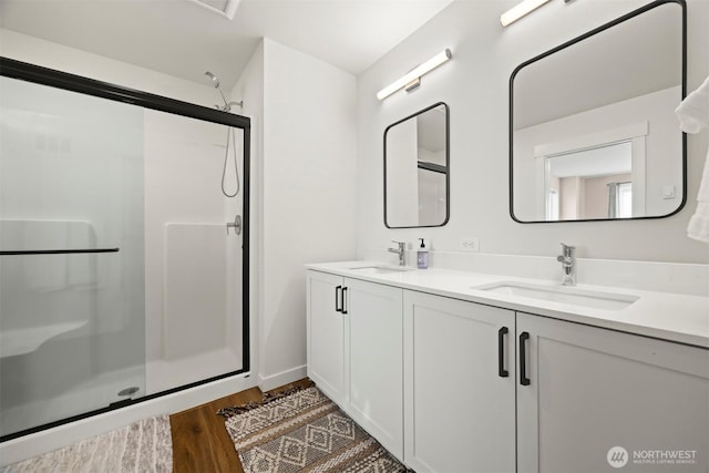 4243 Cameo Ln, Bellingham, WA 98226 - bathroom featuring wood finished floors, a stall shower, and double vanity