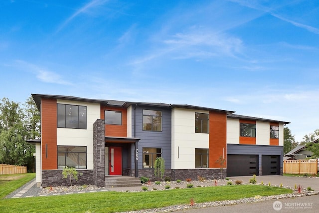 2768 W Wiser Lake Ct, Ferndale, WA 98248 - contemporary house featuring stone siding, an attached garage, and concrete driveway