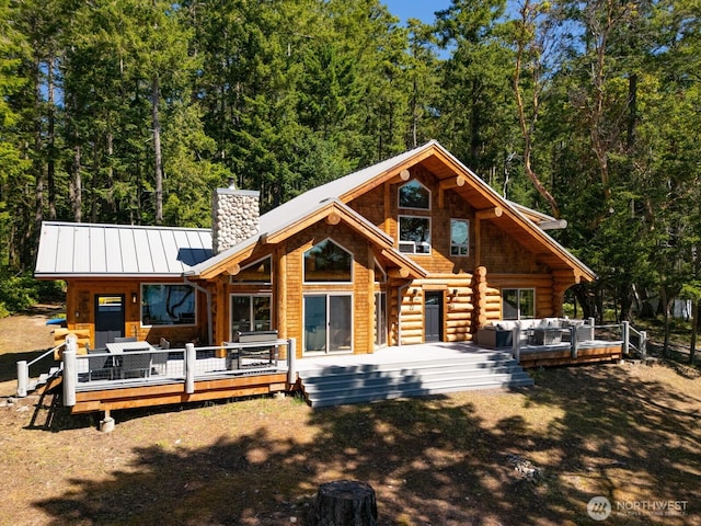 40 Driftwood Shrs, Henry Island, WA 98250 - back of house featuring a chimney, a standing seam roof, a wooden deck, a metal roof, and log exterior