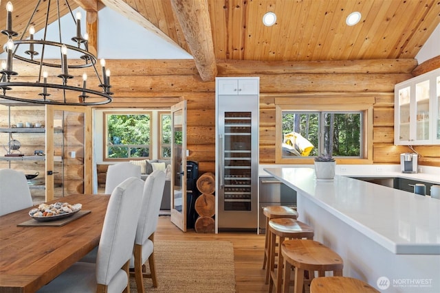 40 Driftwood Shrs, Henry Island, WA 98250 - dining room with beverage cooler, light wood-style floors, recessed lighting, rustic walls, and a chandelier