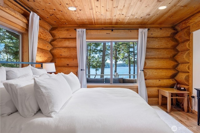 40 Driftwood Shrs, Henry Island, WA 98250 - bedroom with log walls, wood finished floors, recessed lighting, a water view, and wood ceiling