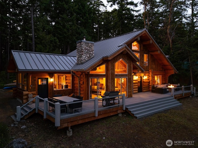 40 Driftwood Shrs, Henry Island, WA 98250 - rear view of house featuring a standing seam roof, an outdoor hangout area, a chimney, a metal roof, and a deck
