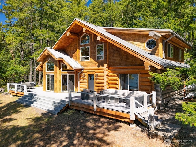 40 Driftwood Shrs, Henry Island, WA 98250 - rear view of property with an outdoor hangout area, a metal roof, log siding, and a wooden deck