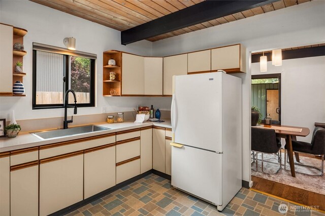 6602 35th St W, University Place, WA 98466 - kitchen featuring freestanding refrigerator, open shelves, cream cabinetry, a wooden ceiling with exposed beams, and light countertops