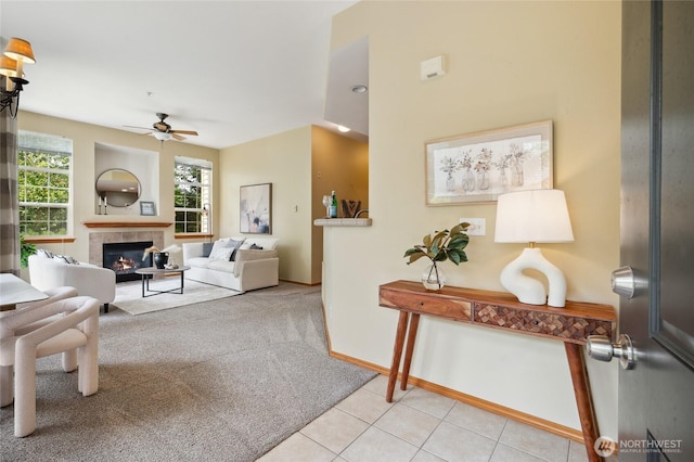 1855 Trossachs Blvd SE Unit 2002, Sammamish, WA 98075 - living room featuring a ceiling fan, a tile fireplace, light colored carpet, and light tile patterned floors