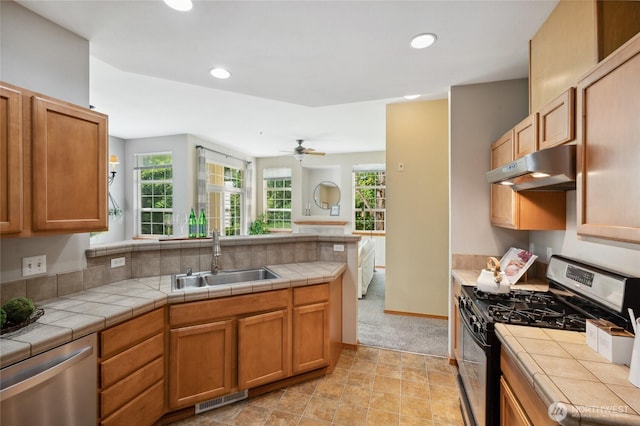 1855 Trossachs Blvd SE Unit 2002, Sammamish, WA 98075 - kitchen featuring appliances with stainless steel finishes, under cabinet range hood, tile countertops, recessed lighting, and a peninsula