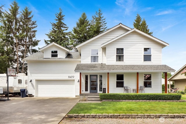 8419 Double Ditch Rd, Lynden, WA 98264 - view of front of home with a front yard, concrete driveway, roof with shingles, and a porch
