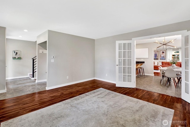 8419 Double Ditch Rd, Lynden, WA 98264 - empty room with wood finished floors, a chandelier, french doors, stairs, and recessed lighting
