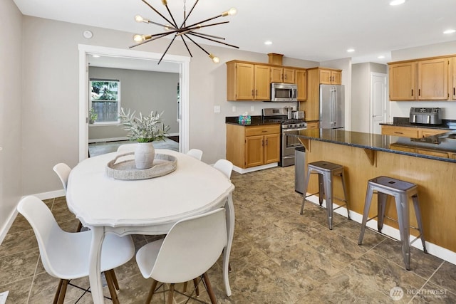 8419 Double Ditch Rd, Lynden, WA 98264 - kitchen with appliances with stainless steel finishes, a breakfast bar area, a chandelier, and recessed lighting