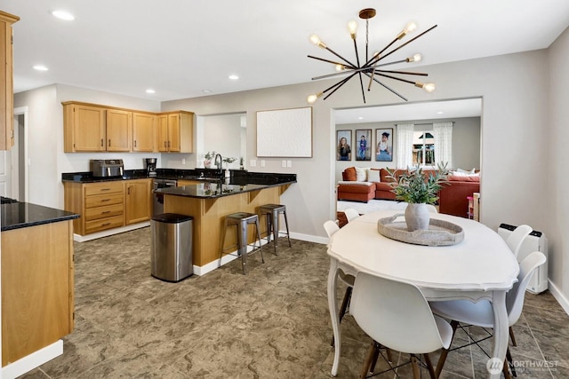 8419 Double Ditch Rd, Lynden, WA 98264 - kitchen with a peninsula, a chandelier, a kitchen bar, recessed lighting, and light brown cabinets